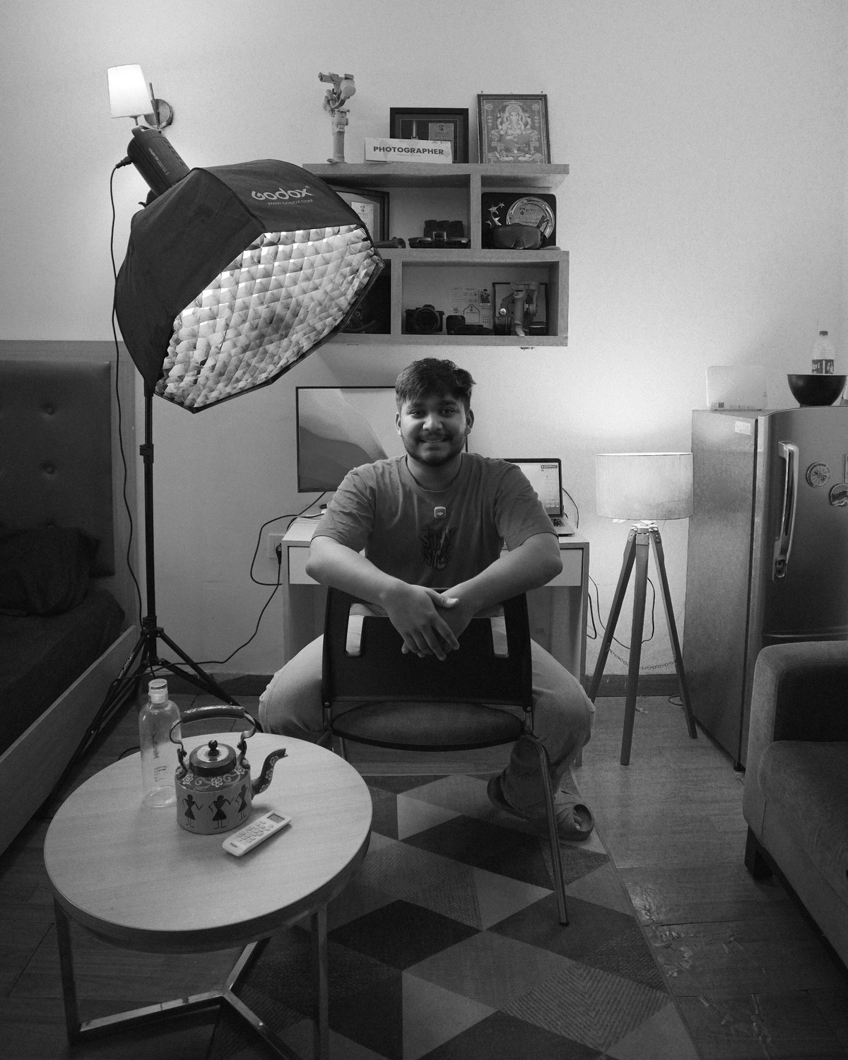 Richi Rich, filmmaker and cinematographer, seated in his studio beside a softbox lighting setup